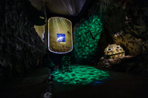 A visitor to The Loch Ness Centre, enjoying the immersive underwater Waters of the Loch experience in a wheelchair