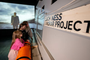 Mother and 2 daughters looking at the John Murray Vessel