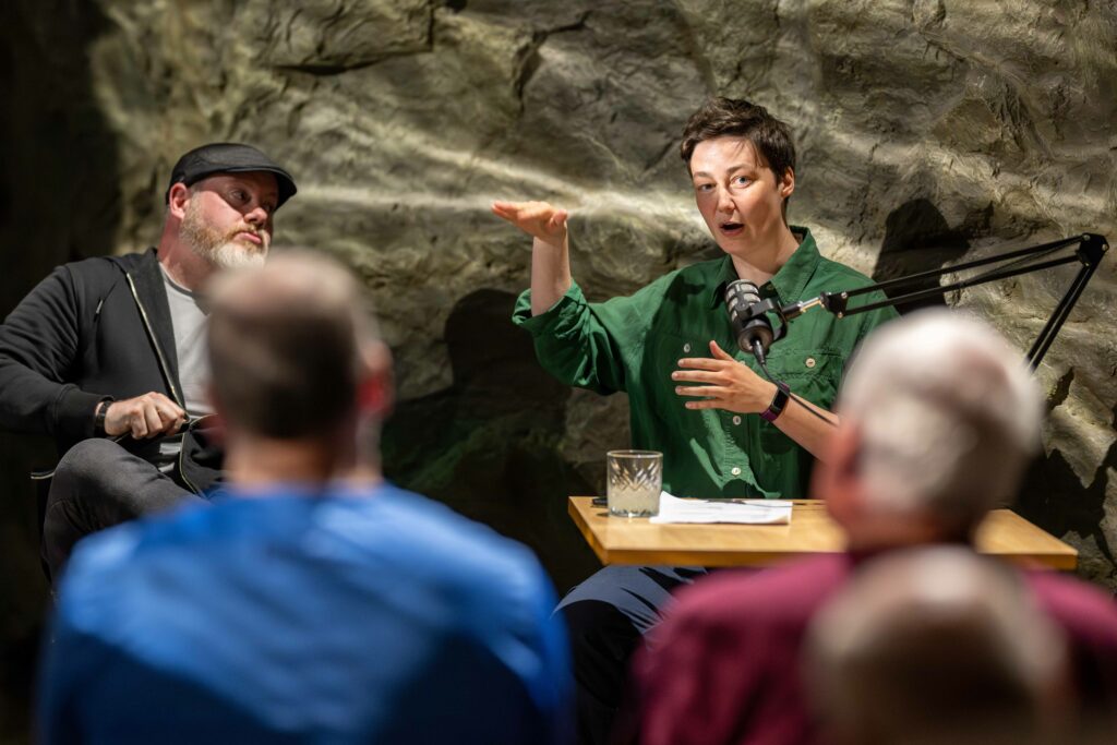 Two women laughing as they talk about a shared experience at The Loch Ness Centre