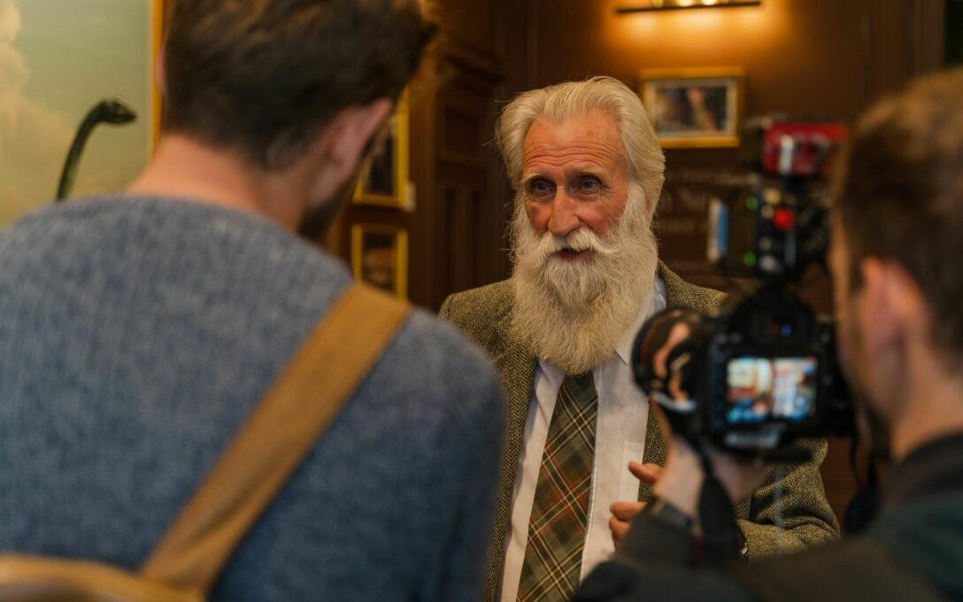 Adrian Shine in The Loch Ness Centre talking to the press