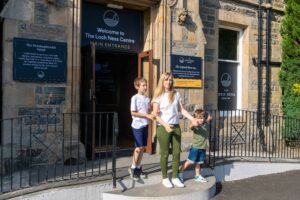 A family outside The Loch Ness Centre