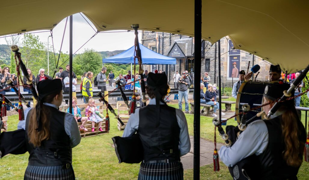 Pipers on the lawn at The Loch Ness Centre during The Quest Weekend