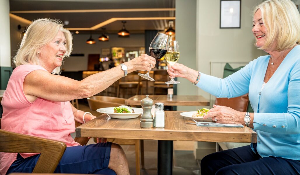 Two ladies enjoying a meal at The Loch Ness Inn that's only a 5 minute drive from The Loch Ness Centre