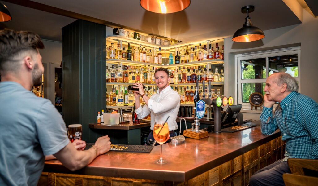 Behind the bar at The Loch Ness Inn with Murray
